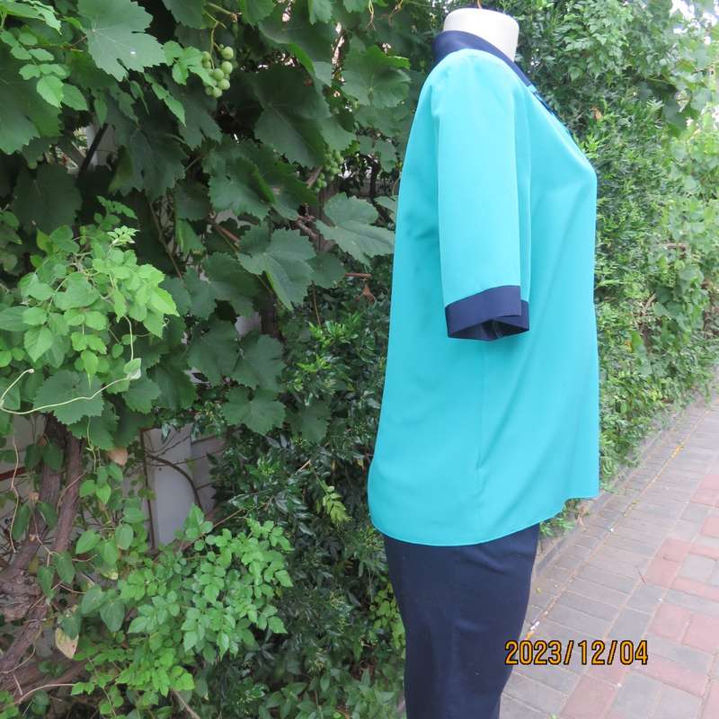 Beautiful jade silky polyester short sleeve top with navy open collar. By WOOLWORTHS size 38. As new