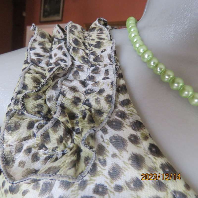 Pretty cool animal  print pale green/black blouson/peplum sheer poly/lined top. Size 36. As new.