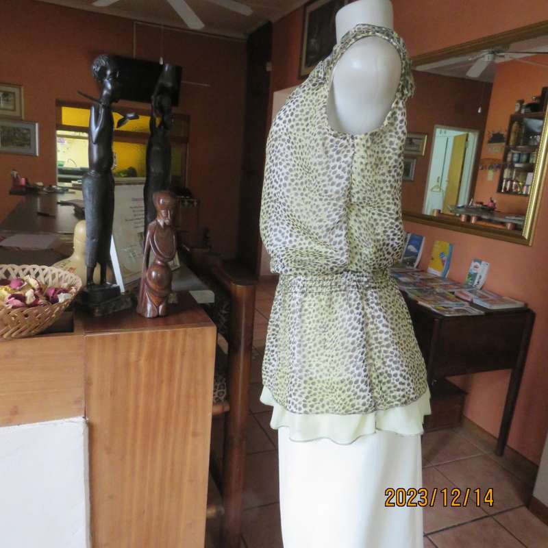 Pretty cool animal  print pale green/black blouson/peplum sheer poly/lined top. Size 36. As new.