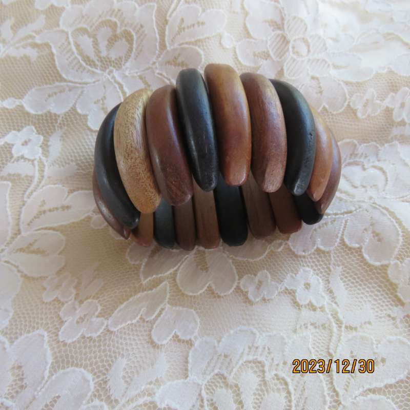 Stunning wooden stretch bracelet made up of different woods. Width 5cm. New condition.