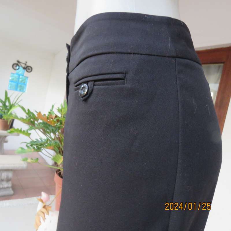 Very black bootlegged smart WOOLWORTHS polyester pants size 36/12. Inner leg 73cm. As new.