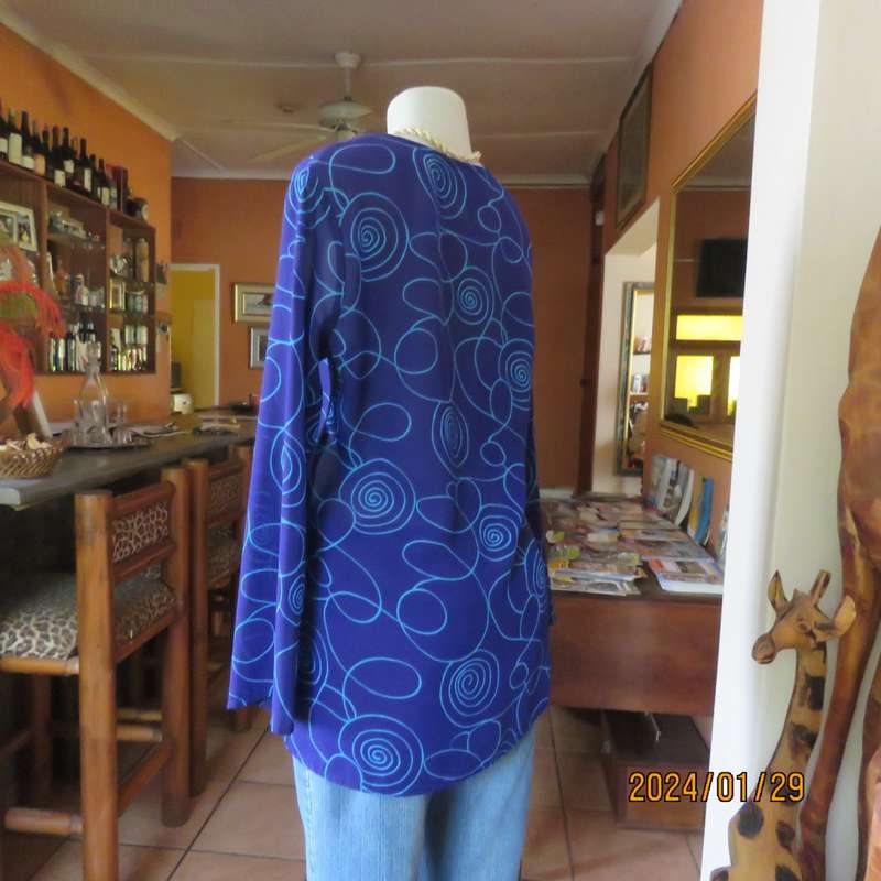 Make a statement in this indigo blue long sleeve top with turquoise twirls.Size 36.By FOSHINI.As new