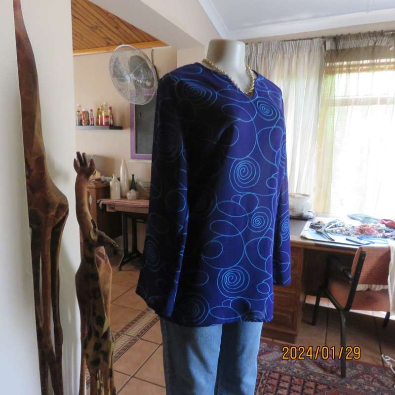 Make a statement in this indigo blue long sleeve top with turquoise twirls.Size 36.By FOSHINI.As new