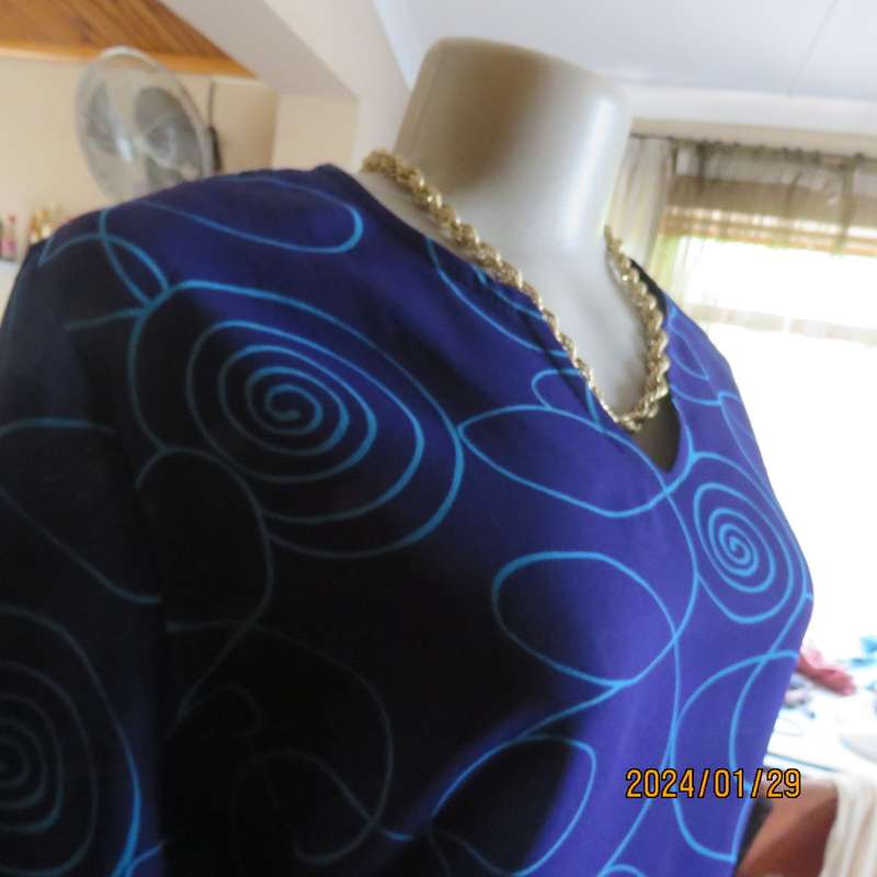 Make a statement in this indigo blue long sleeve top with turquoise twirls.Size 36.By FOSHINI.As new