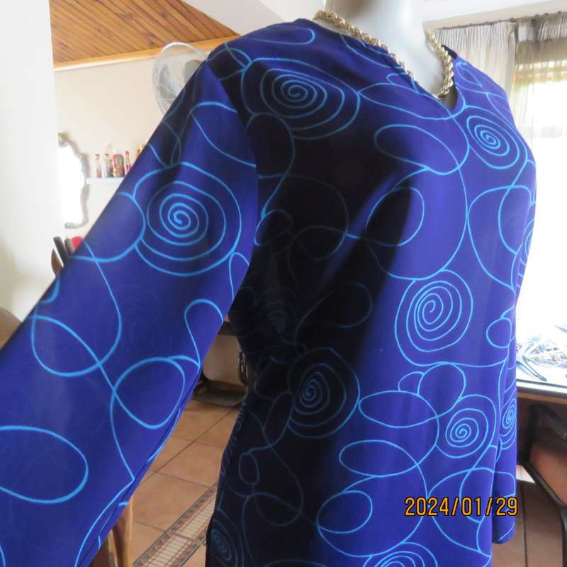 Make a statement in this indigo blue long sleeve top with turquoise twirls.Size 36.By FOSHINI.As new