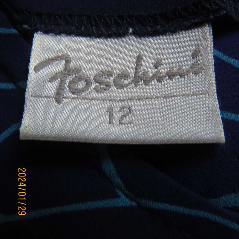 Make a statement in this indigo blue long sleeve top with turquoise twirls.Size 36.By FOSHINI.As new