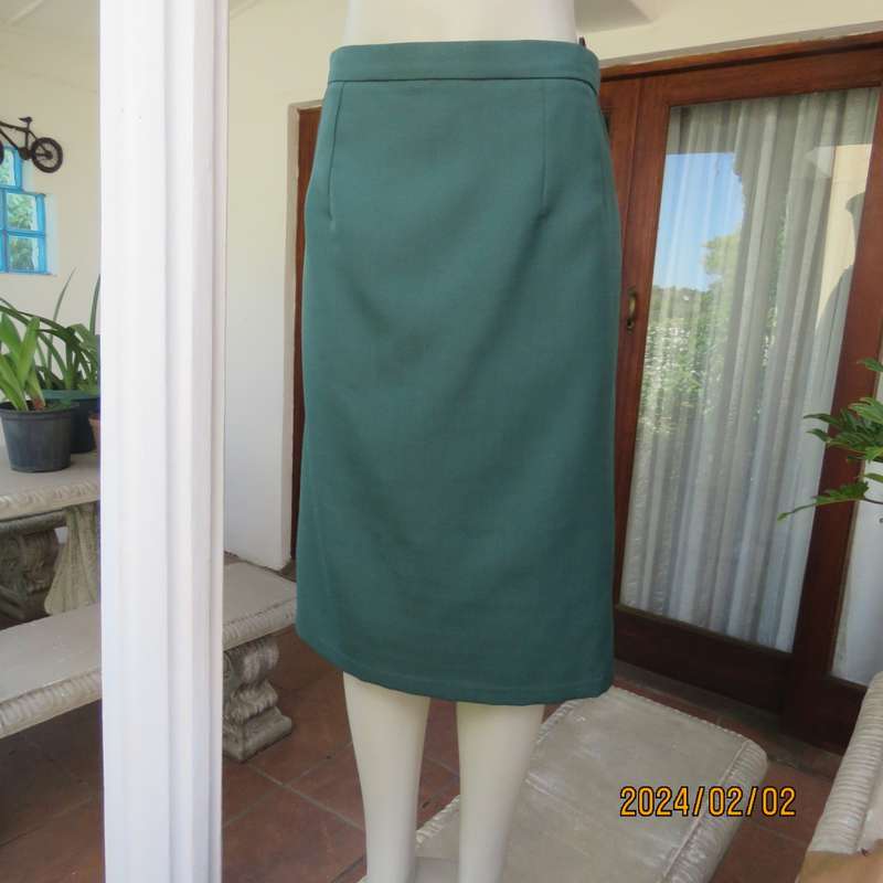 Smart dark green bottle green fully lined pencil size 36 skirt. With pleat and zip at back. As new.