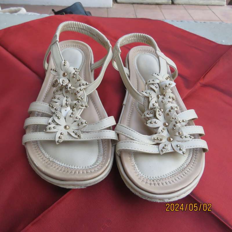 As new pair beige sandals. Stretch heel band and floral bands over foot.Size 8 by MILADYS.Soft inner