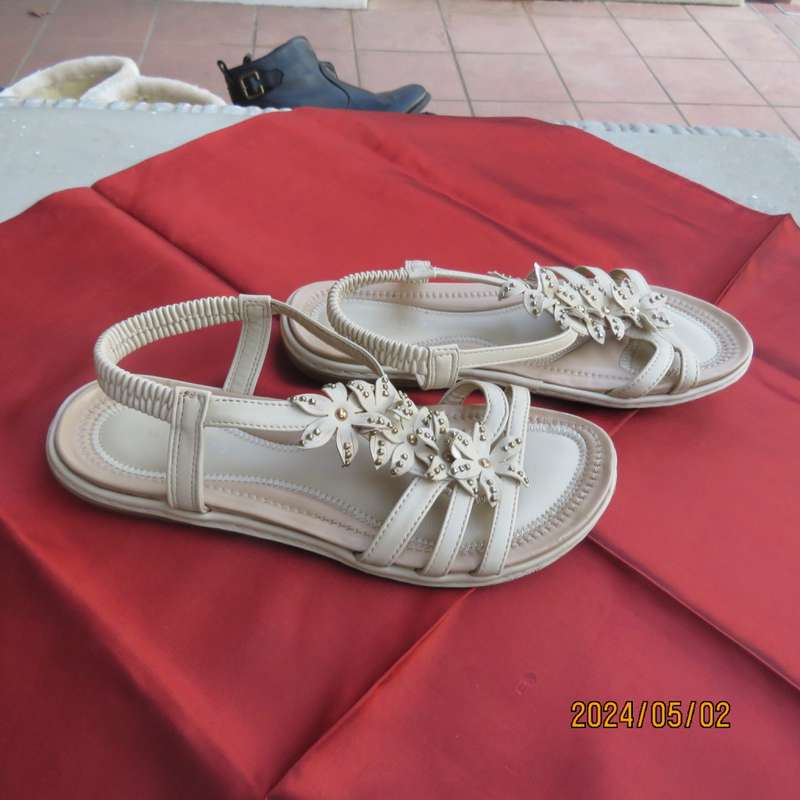As new pair beige sandals. Stretch heel band and floral bands over foot.Size 8 by MILADYS.Soft inner