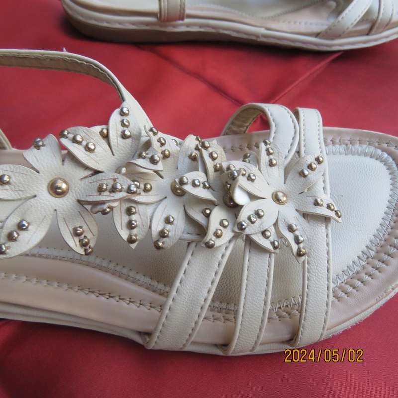 As new pair beige sandals. Stretch heel band and floral bands over foot.Size 8 by MILADYS.Soft inner