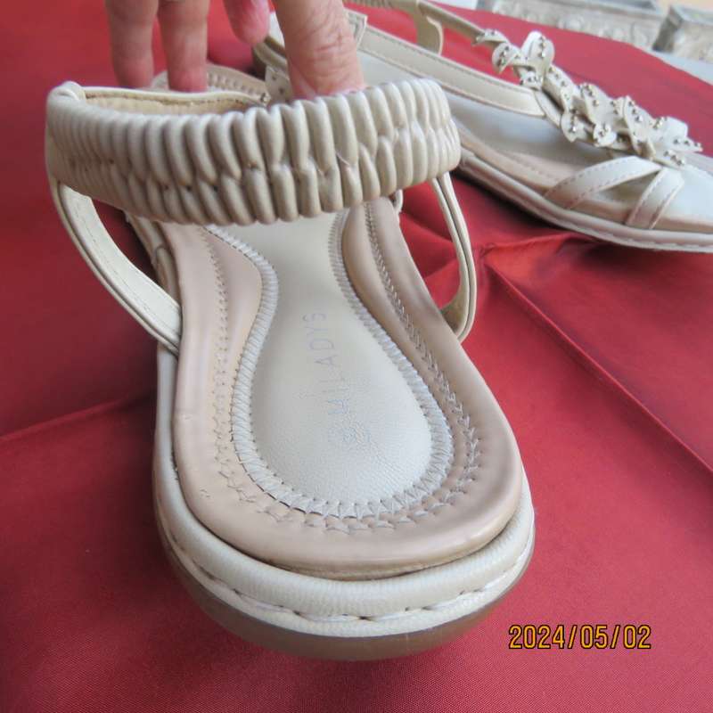 As new pair beige sandals. Stretch heel band and floral bands over foot.Size 8 by MILADYS.Soft inner