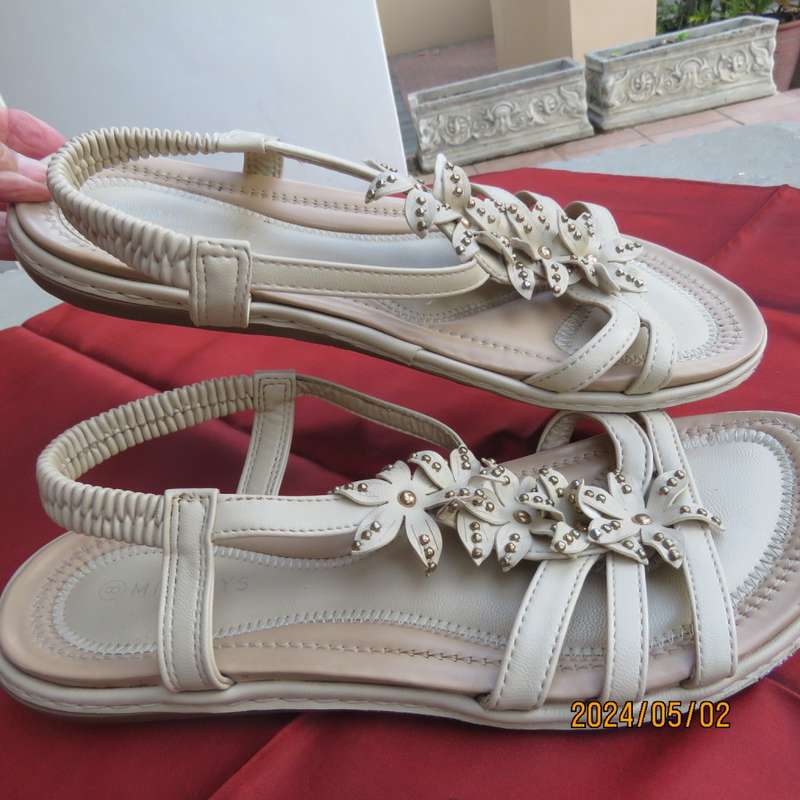 As new pair beige sandals. Stretch heel band and floral bands over foot.Size 8 by MILADYS.Soft inner