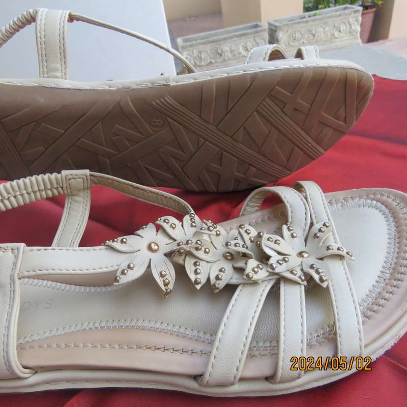 As new pair beige sandals. Stretch heel band and floral bands over foot.Size 8 by MILADYS.Soft inner