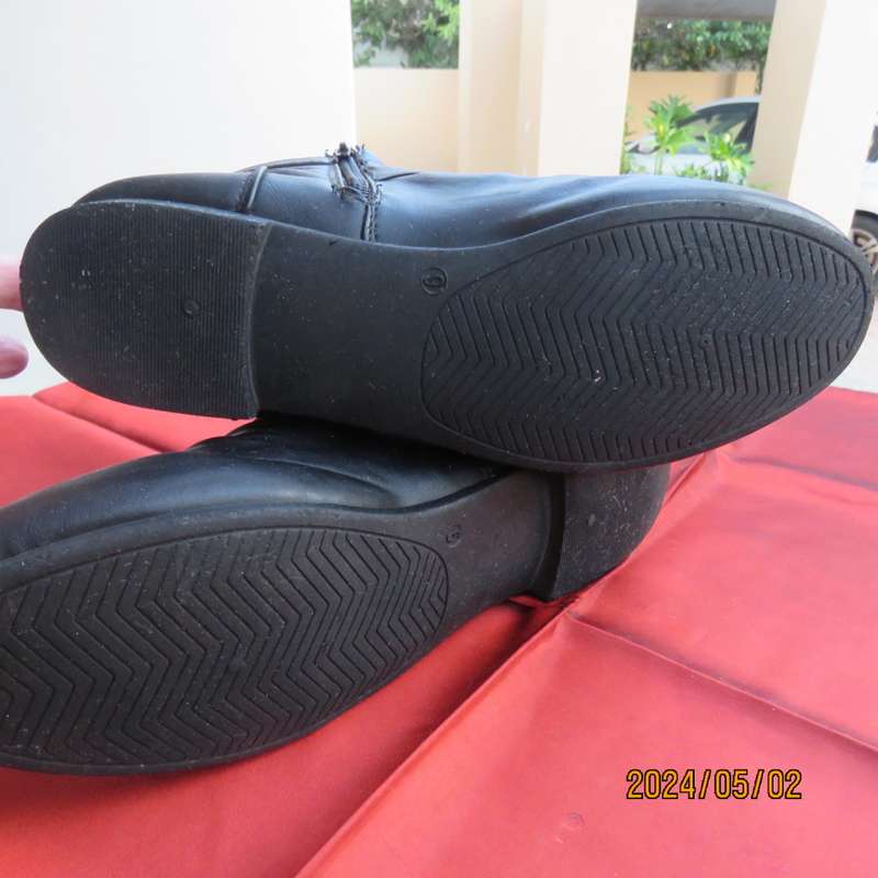 Pair of black faux leather booties in size 9 with side zips. Also an adjustable strap. Very good con