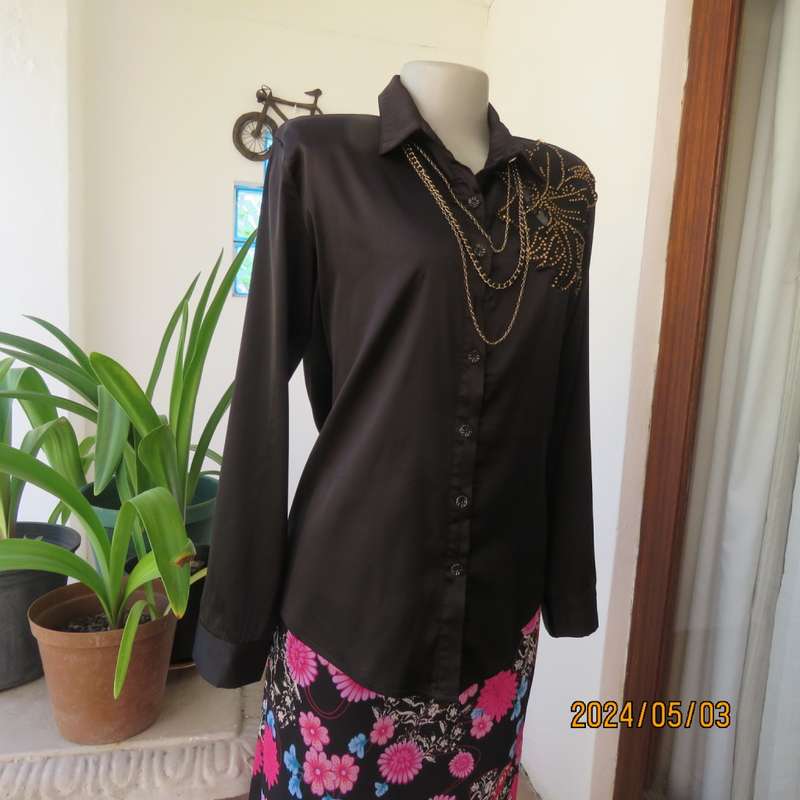 Get noticed in this black silky,shiny stretch poly long sleeve top size 36/38. Luxury embellishment.