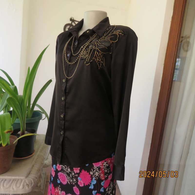 Get noticed in this black silky,shiny stretch poly long sleeve top size 36/38. Luxury embellishment.