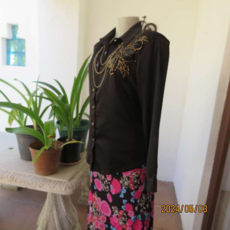Get noticed in this black silky,shiny stretch poly long sleeve top size 36/38. Luxury embellishment.