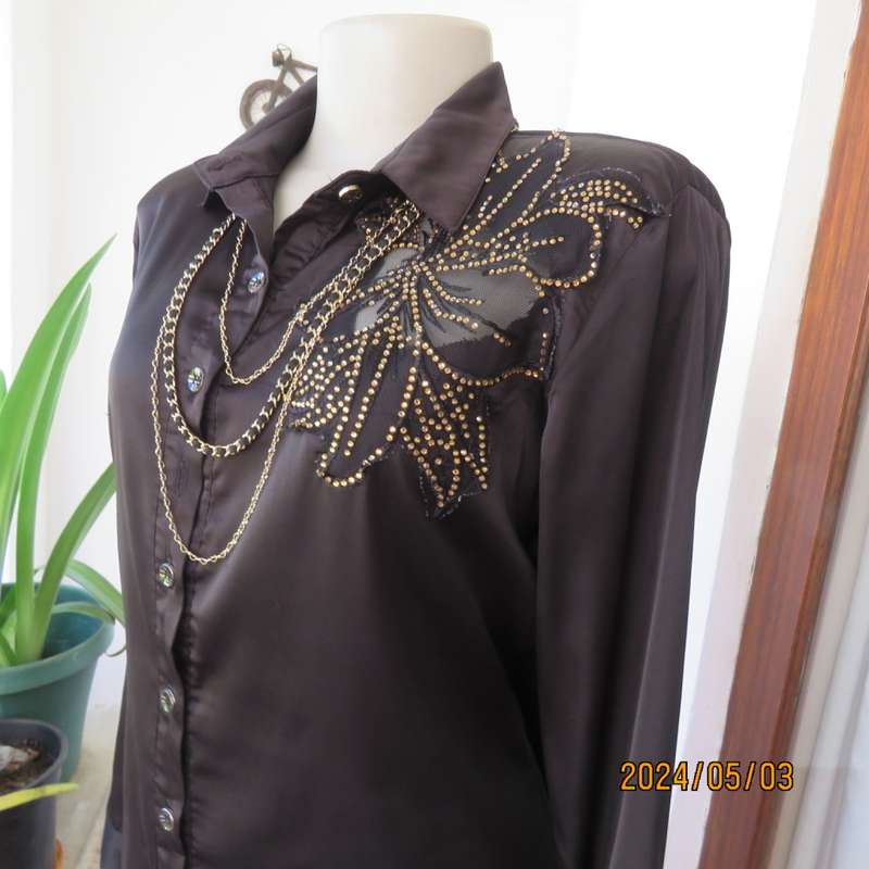 Get noticed in this black silky,shiny stretch poly long sleeve top size 36/38. Luxury embellishment.