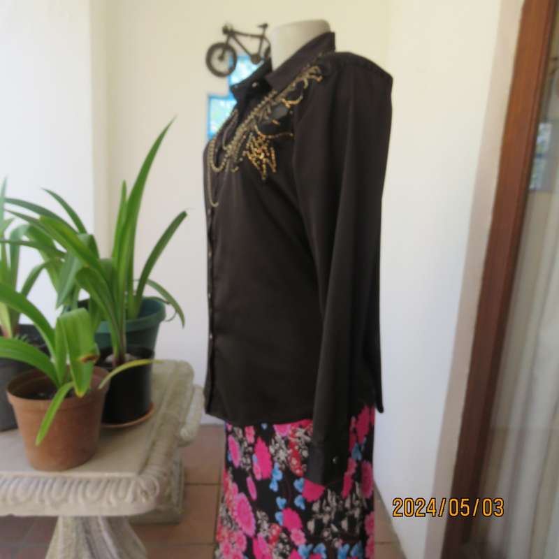 Get noticed in this black silky,shiny stretch poly long sleeve top size 36/38. Luxury embellishment.