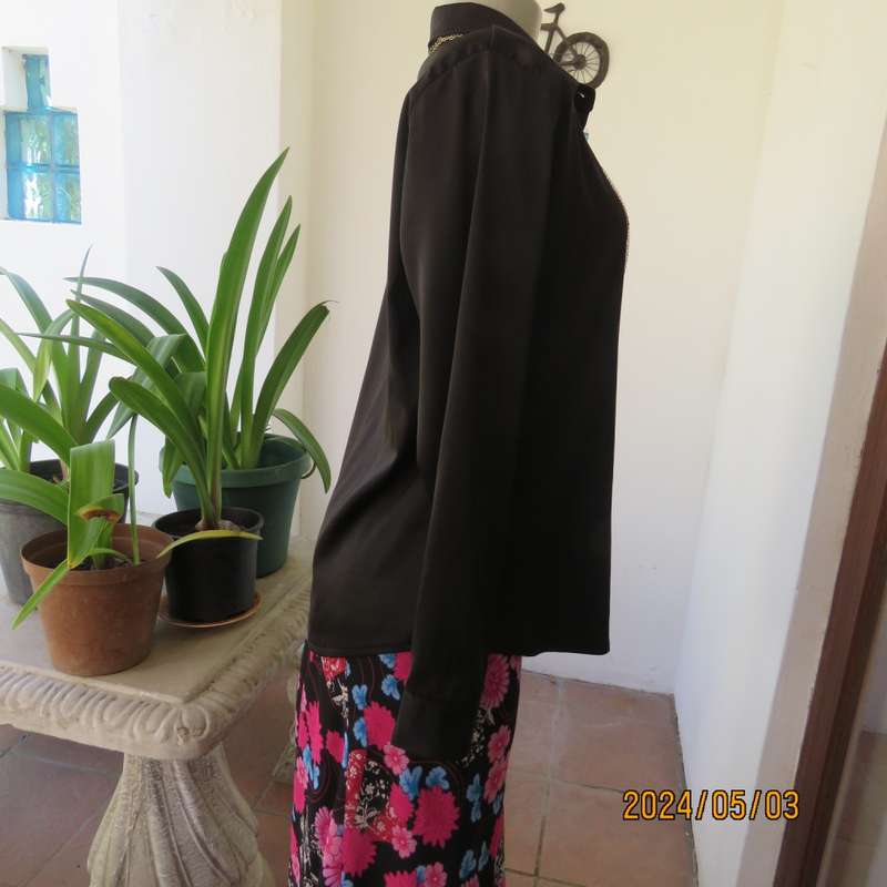 Get noticed in this black silky,shiny stretch poly long sleeve top size 36/38. Luxury embellishment.