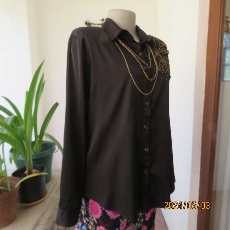 Get noticed in this black silky,shiny stretch poly long sleeve top size 36/38. Luxury embellishment.
