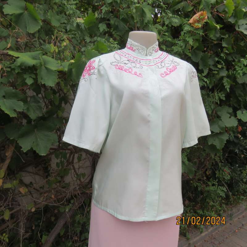 Amazing mint green silk blouse with short sleeves . Hidden button down.Luxe embroidery.By BONITA 35.