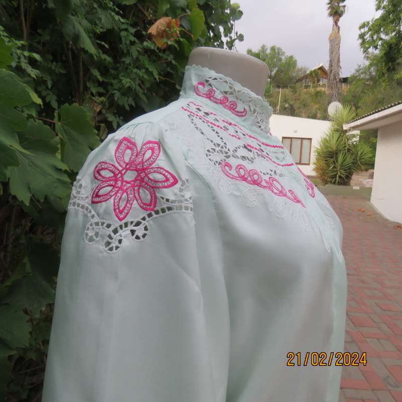 Amazing mint green silk blouse with short sleeves . Hidden button down.Luxe embroidery.By BONITA 35.