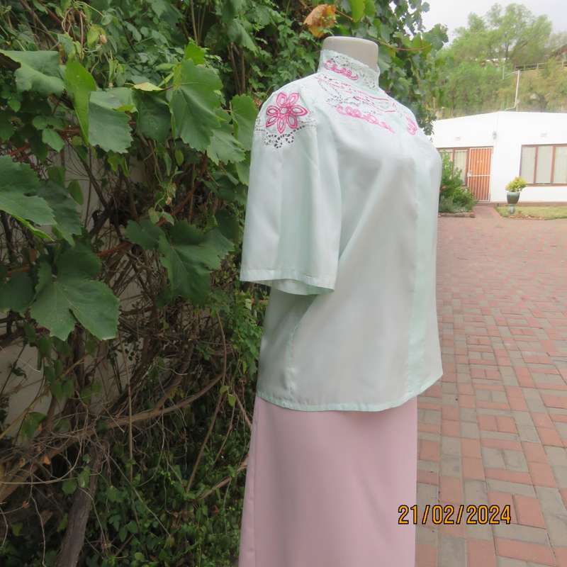 Amazing mint green silk blouse with short sleeves . Hidden button down.Luxe embroidery.By BONITA 35.