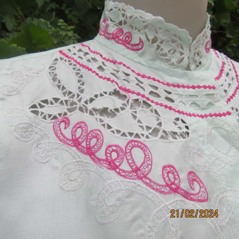 Amazing mint green silk blouse with short sleeves . Hidden button down.Luxe embroidery.By BONITA 35.
