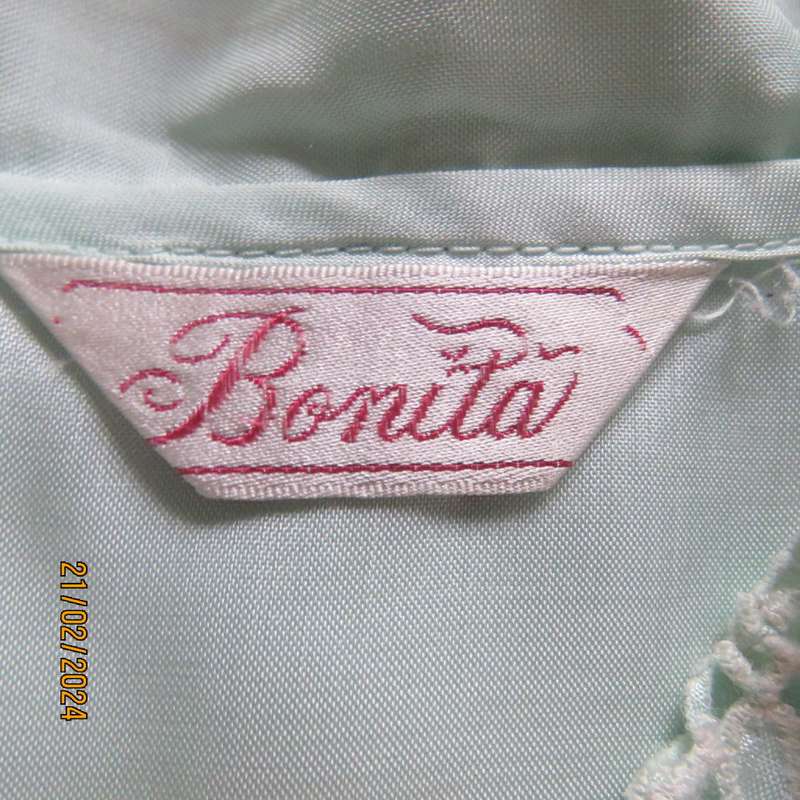 Amazing mint green silk blouse with short sleeves . Hidden button down.Luxe embroidery.By BONITA 35.