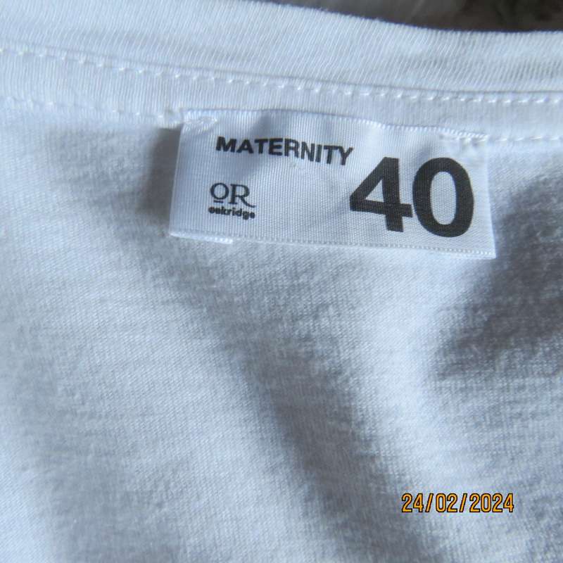 Cute white maternity T Shirt with short sleeves. Logo...YOU AND ME BABY...in gold. Size 40. As new