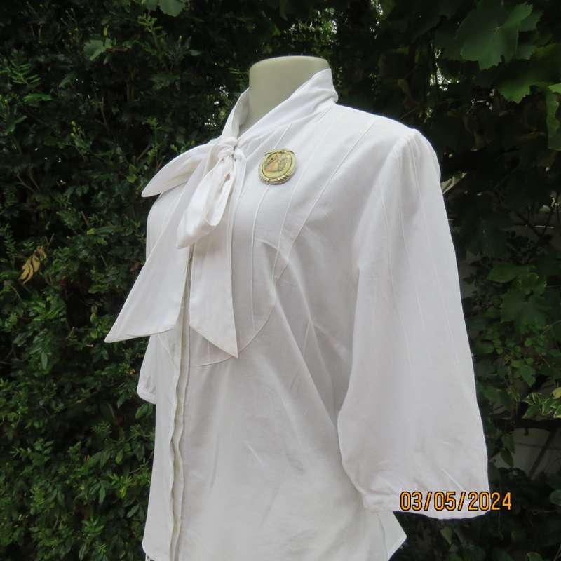 Chic white cotton top with bow collar and hidden button down front.Elbow sleeves. Size 38.As new.
