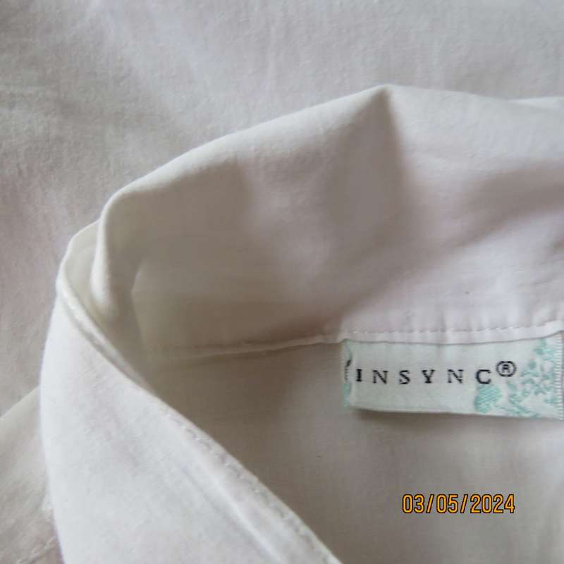 Chic white cotton top with bow collar and hidden button down front.Elbow sleeves. Size 38.As new.