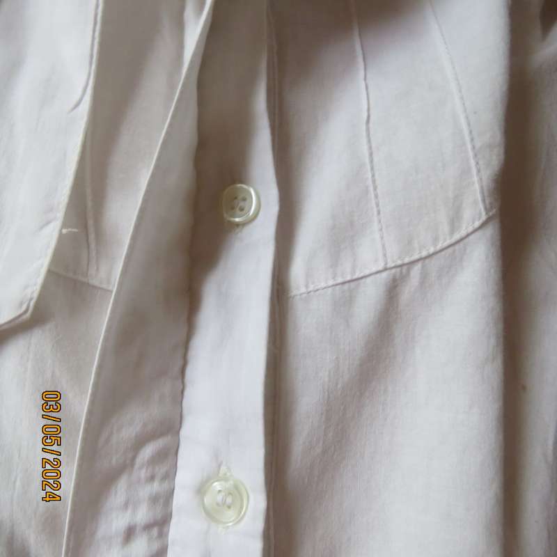 Chic white cotton top with bow collar and hidden button down front.Elbow sleeves. Size 38.As new.