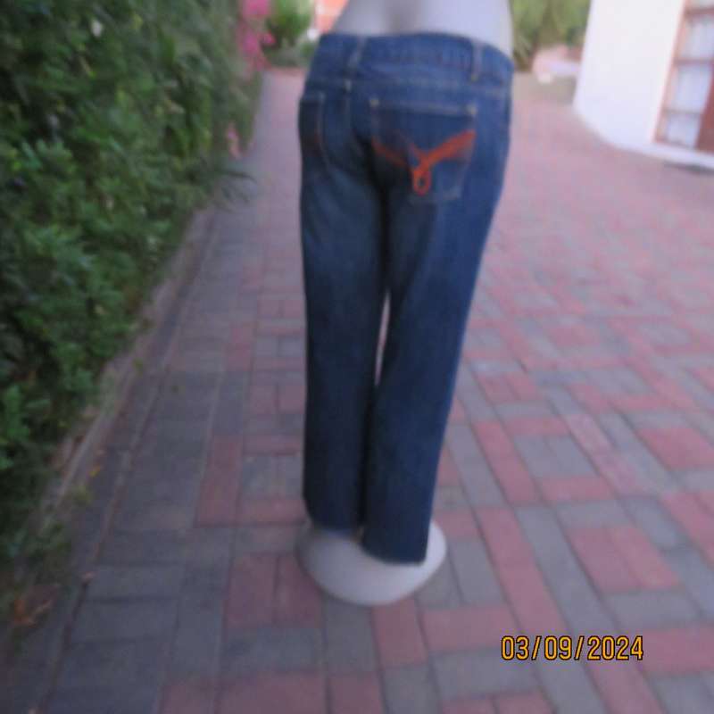 Pair of blue denim cotton Slouch fit low rise jeans by ST BERNARD size 34.Bootlegged. Very good cond