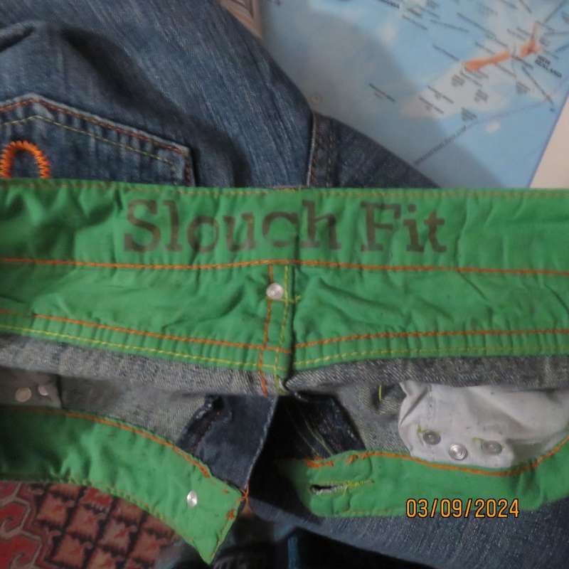 Pair of blue denim cotton Slouch fit low rise jeans by ST BERNARD size 34.Bootlegged. Very good cond