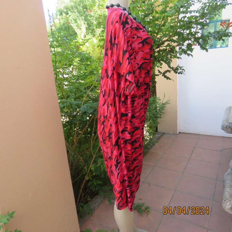 Go for effortless style in this slip over dress in medley of patterns in reds/black.Size 36/38.