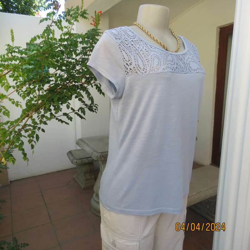 Capped sleeve light blue slip over top with polyester lace yoke. Size 36. Stretch viscose.