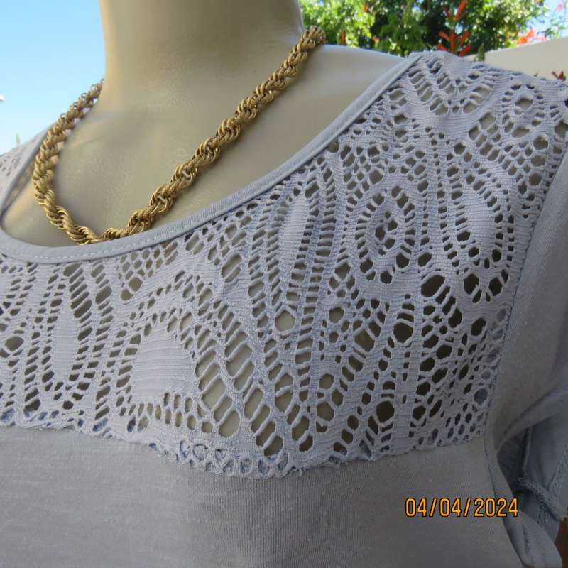 Capped sleeve light blue slip over top with polyester lace yoke. Size 36. Stretch viscose.
