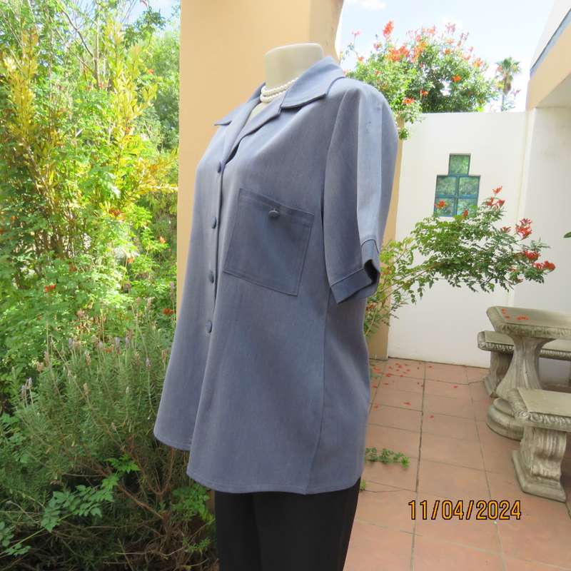 Boutique made short sleeve button down top in blues Polyester-viscose. Size 38.