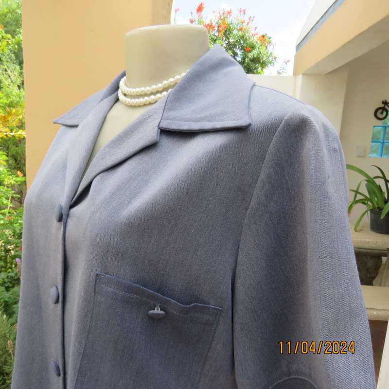 Boutique made short sleeve button down top in blues Polyester-viscose. Size 38.