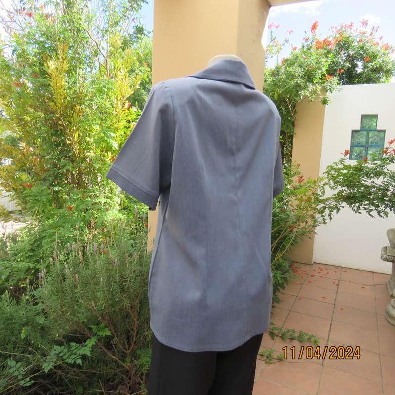 Boutique made short sleeve button down top in blues Polyester-viscose. Size 38.