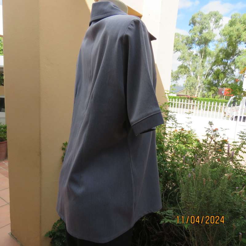 Boutique made short sleeve button down top in blues Polyester-viscose. Size 38.