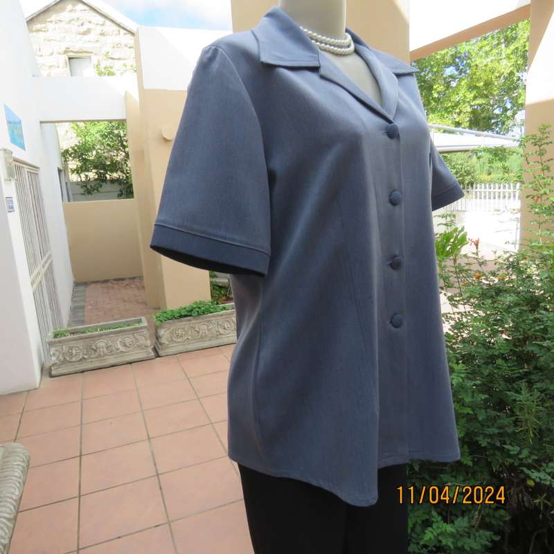 Boutique made short sleeve button down top in blues Polyester-viscose. Size 38.