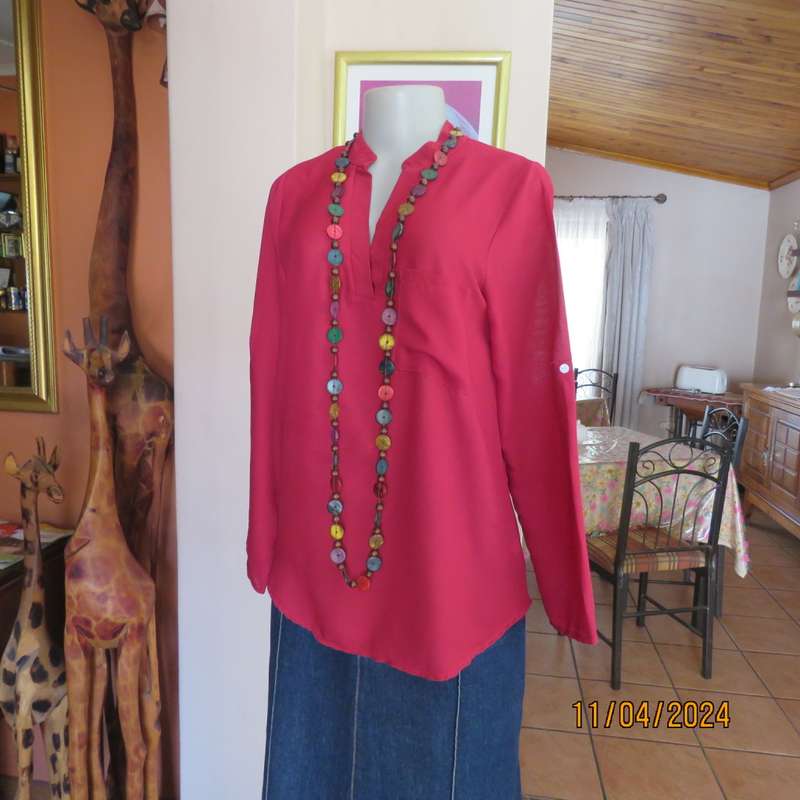 Scarlet red slip over sheer polyester top. Banded collar with V slit. Size 36/12, One pocket. Yoke