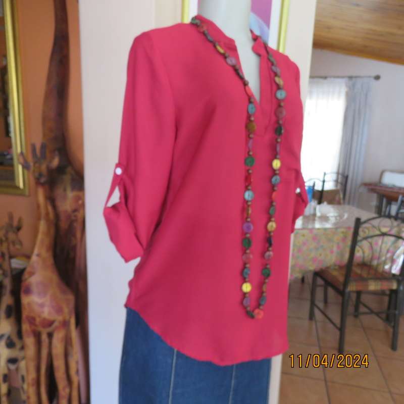 Scarlet red slip over sheer polyester top. Banded collar with V slit. Size 36/12, One pocket. Yoke