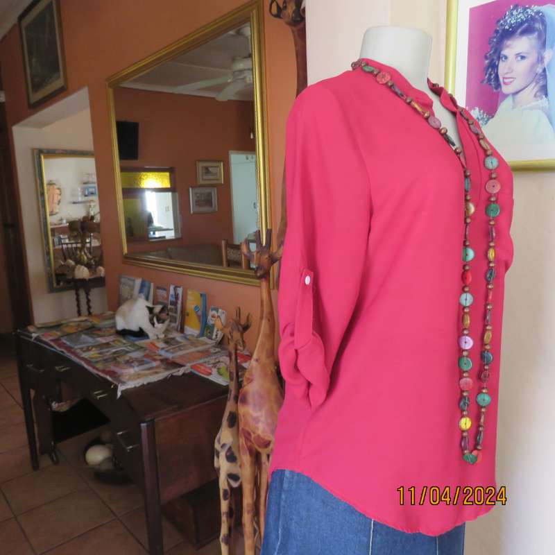 Scarlet red slip over sheer polyester top. Banded collar with V slit. Size 36/12, One pocket. Yoke