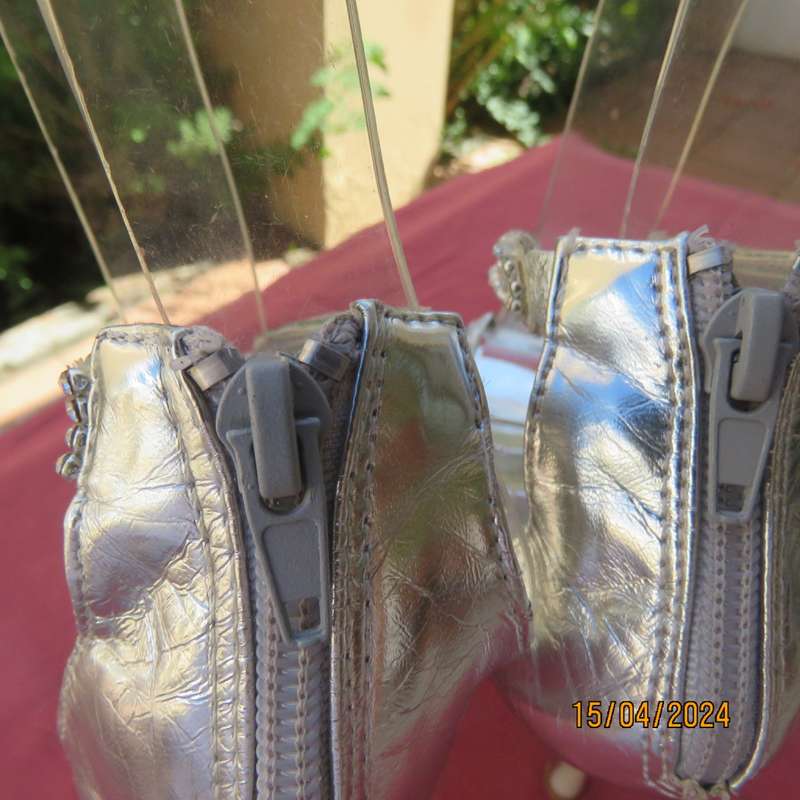 Pair of silver high heel SOLO size 6 open toe sandals. Zip at back. FAUX diamond straps. Used once.