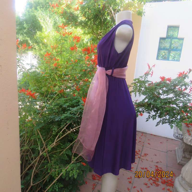 Smart casual purple stretch polyester calf length dress. Low V cross over top. Size 38. As new cond.