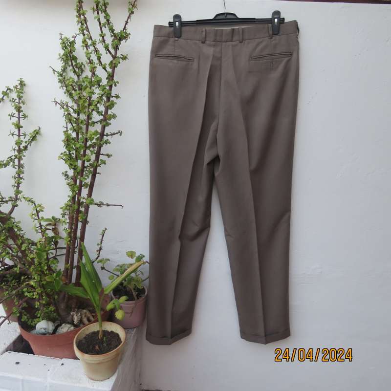 As new Men`s fashion pants in coffee brown polyester/rayon blend. Pleats on front.Size 38. JONTY`S